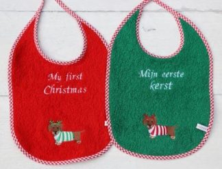 Groene of rode slab met kerst-teckel voor baby's eerste kerst
